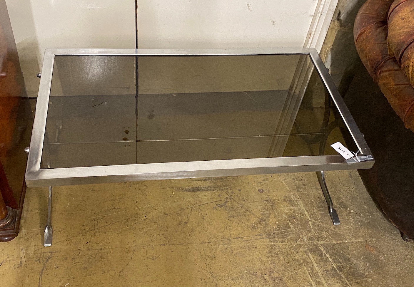 A smoked glass top mid century coffee table, length 107cm, height 61cm